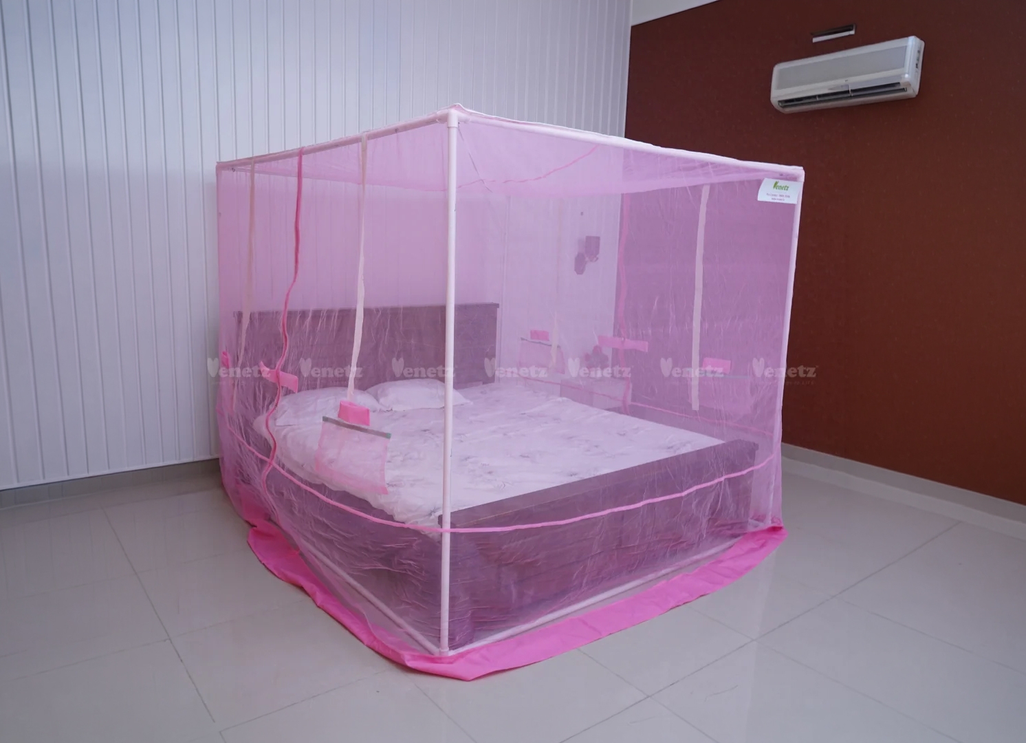Venetz Ezy-Fix mosquito net protecting a bed